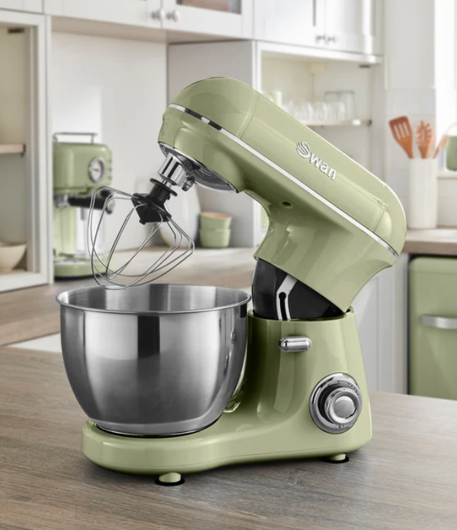A green stand mixer placed on a kitchen counter